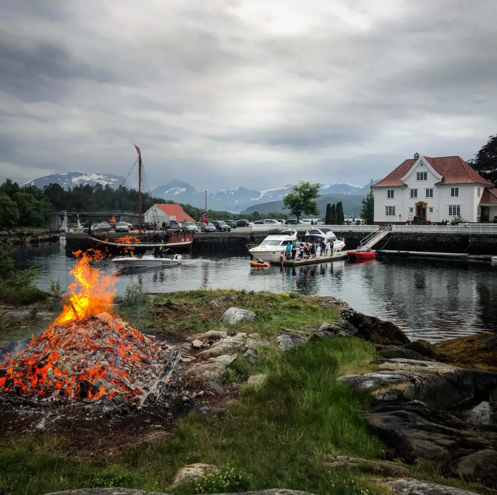 Jonsokfeiring med bål, båtar og hovudhus på Kjeldsund
